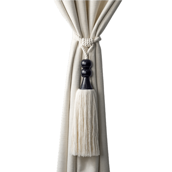 A white curtain tied with a decorative cord and black and white tassel.